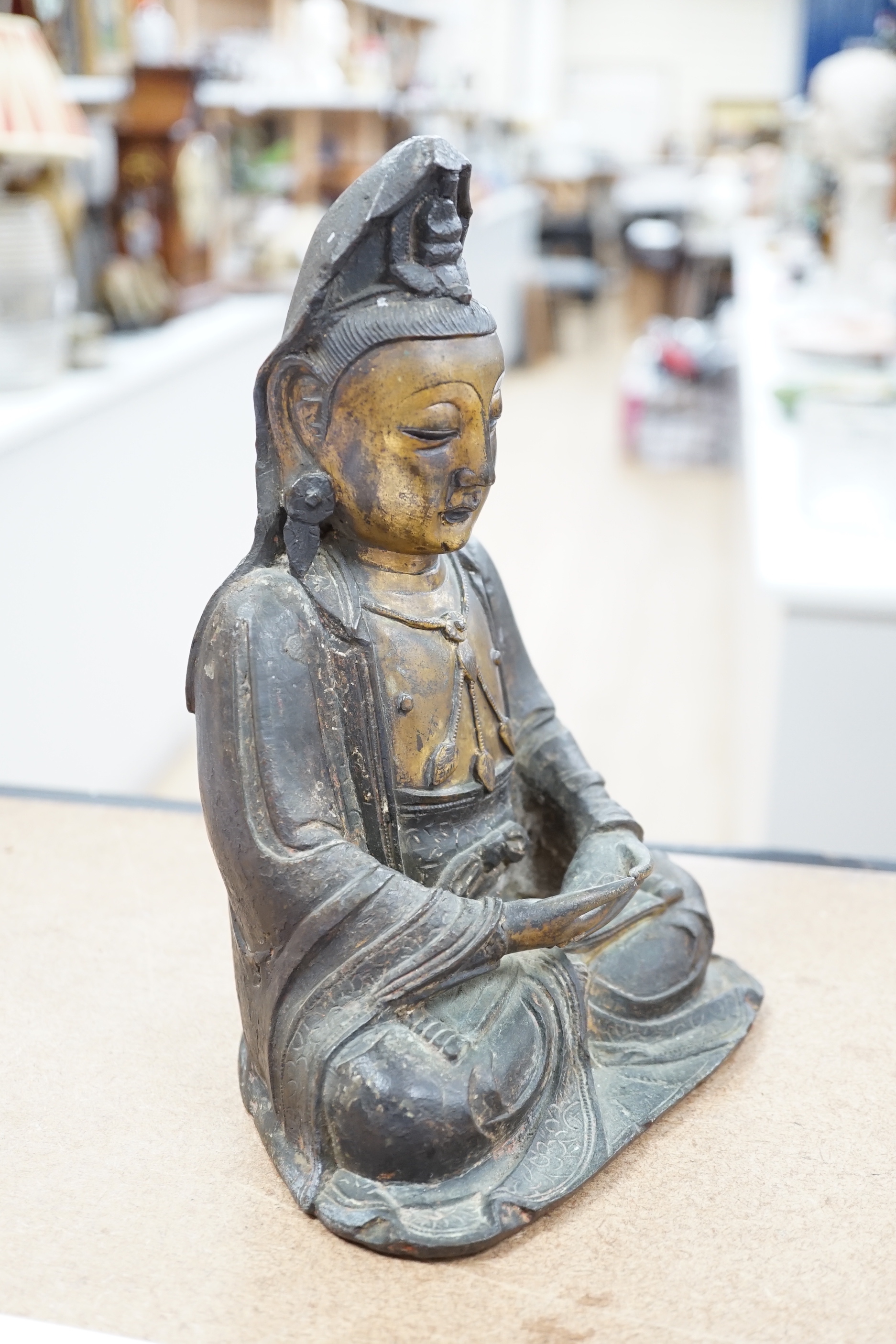 A Chinese Ming gilt bronze figure of Xi Wangmu, Queen Mother of the West, late 16th / early 17th century, Provenance: bought from the 50th Chelsea Antiques Fair, R & D Coombes, 1980, 24cm high